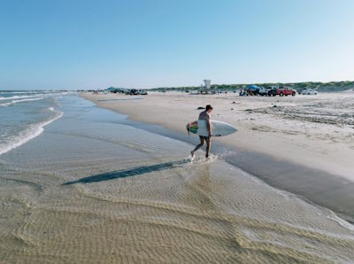 Surfer on the beach at South Padre Island, Texas